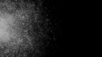 Black background filled with sequins. Motion. Orange and white glitter in the animation that crumbles in different directions. video