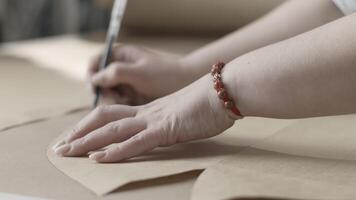 Designer creates patterns in a fashion studio with precision and creativity in handson work video