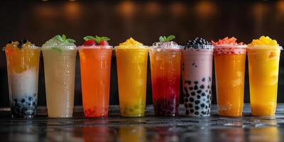 Colorful Bubble Tea Drinks With Boba Pearls On A Black Countertop photo