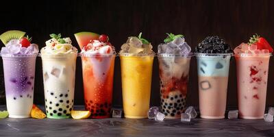 Colorful Bubble Tea Drinks With Boba Pearls On A Black Countertop photo