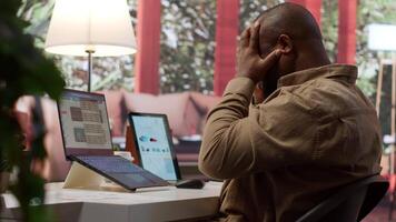 Business analyst calculating project funds and analytics at his home, allocating resources and solving tasks to accomplish objectives. Entrepreneur works on money management accounting. Camera A. video