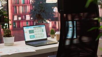 Empty home setup belonging to an entrepreneur with data sales analytics and financial reports on laptop, accountancy information and invoices for remote work. Finance and economy. video