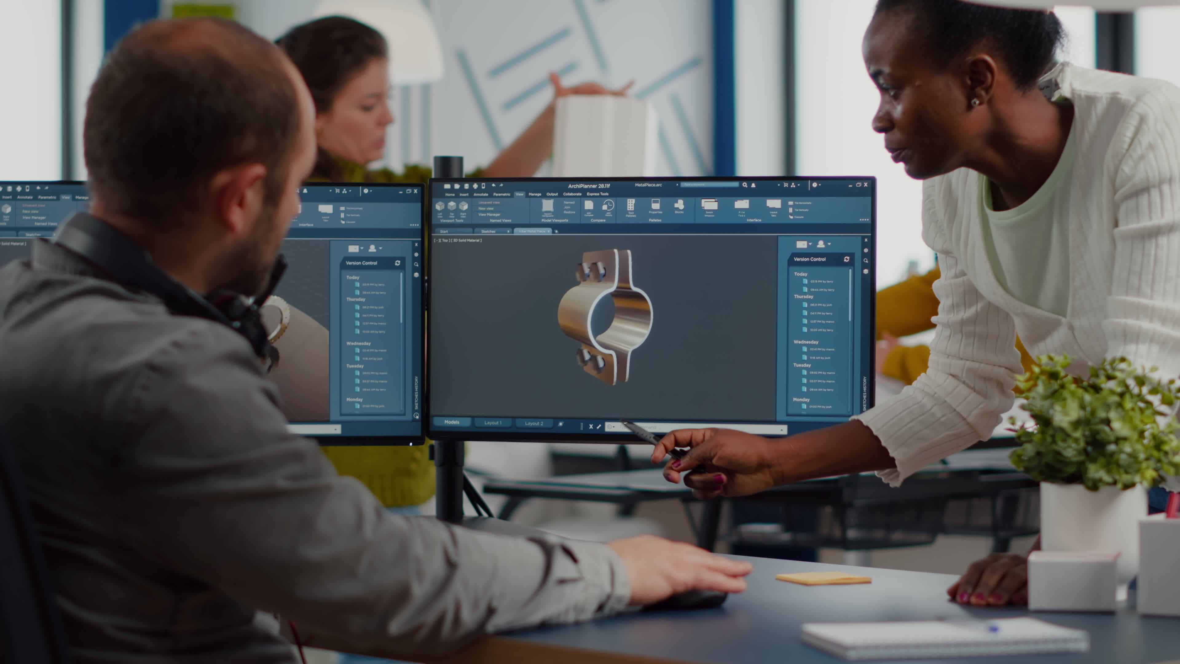 Diverse team discussing about industrial project using dual monitors ...