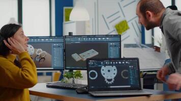 Industrial development engineer analysing and sharing ideas with project manager working on computer. Team of professionals using CAD Software for modern industrial engineering design. video