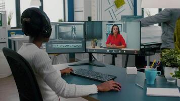 Black woman videographer in web online conference with project manager on call editing client work, getting feedback on commercial movie using post production software on pc in start up office video