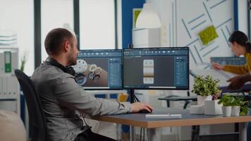 Black employee and project manager analysing mechanical metalic parts, 3D cad program with gears shape, software with new prototypes. Industrial engineer and afro colleague working in creative office video
