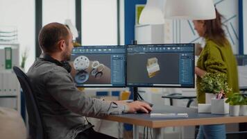 Industrial engineer and african project manager working on 3D construction metalic components in CAD software. Diverse team discussing about technical project analysing mechanical prototype. video
