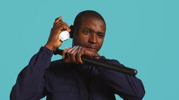 Headshot portrait of security staff member evicting trespassers with baton after spotting them with flashlight. Close up of patrolling agent using truncheon and lantern to evict intruders, camera B video