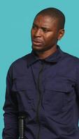 Vertical Anxious security guard shaking head, having trouble following orders during protection job shift. Portrait of troubled bodyguard feeling stressed, having problems at work, studio background, camera A video