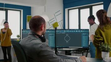 Focused engineer putting on headphones working with technical cad program, checking 3D gears prototypes, drawing with stylus pencil on graphic tablet Industrial architect studying prototype idea on pc video