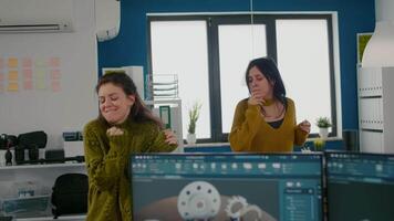 Enthusiastic diverse engineers women dancing in company office celebrating success of project, singing and having fun during working hours. Authentic footage of happy real people enjoying life video