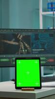 Vertical . Team of scientists working in background of modern laboratory using tablet with green screen, mockup display, isolated chroma key monitor, analysing experiment evolution, high tech development lab. video
