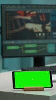 Vertical . Horizontal mobile phone with green screen working in labooratory with mock up template, chroma key display while professional engineer testing virus evolution in background. High tech development lab. video