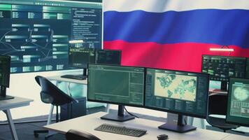 Surveillance and hacking room with a Russian flag on big screen, representing cyber espionage and digital manipulation. Russian government works on propaganda and misinformation campaigns. Camera B. video