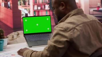 Financial adviser works with infographics next to a copy space mockup display, using accounts balance to create a correct economic report. Entrepreneur examines business data. Camera A. video