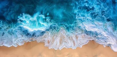 Aerial View of Turquoise Ocean Waves Breaking on Sandy Beach photo