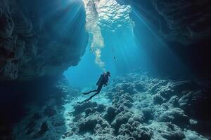 Underwater Scuba Diver Exploring a Coral Reef Cave With Schools of Fish photo