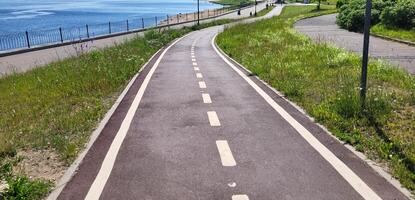 A red synthetic treadmill or bicycle path with white markings, with a turn. photo