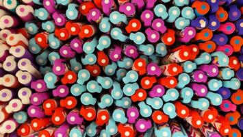 Abstract background of multicolored caps of plastic pens. A set of several liners, markers and colored markers of different colors, top view photo