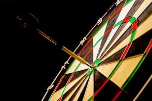 Fragment of target with dart in bullseye photo