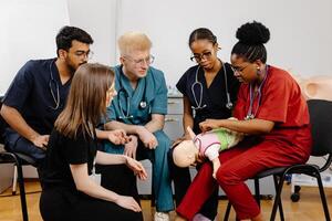 Medical Students Practicing CPR on a Baby Mannequin photo