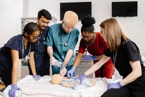 Medical Students Practicing CPR on a Baby Mannequin photo