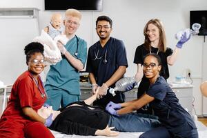 A group of medical students practice CPR on a mannequin during a training session photo