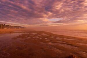 Sunrise with clouds and fog on beach in Florianopolis photo