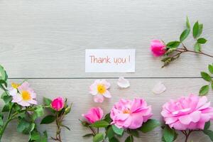 light wooden background with bright pink roses photo