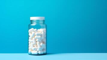A close-up image of a prescription bottle filled with pills and capsules. The bottle is white and has a white cap. The pills are red, orange, and white. The background is blue. photo