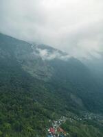 clouds over the mountains, mountains in the fog, during annapurna base camp, ghandruk, nepal photo