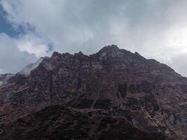 clouds over the mountains, mountains in the fog, during annapurna, annapurna base camp nepal photo