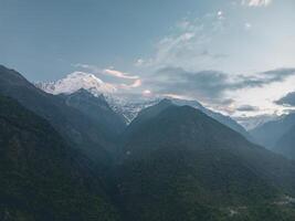 clouds over the mountains, mountains in the fog, during annapurna base camp, ghandruk, nepal photo