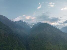 clouds over the mountains, mountains in the fog, during annapurna base camp, ghandruk, nepal photo