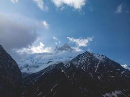 clouds over the mountains, mountains in the fog, during annapurna, annapurna base camp nepal photo
