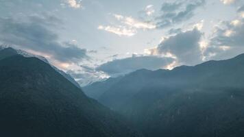 clouds over the mountains, mountains in the fog, during annapurna base camp, ghandruk, nepal photo
