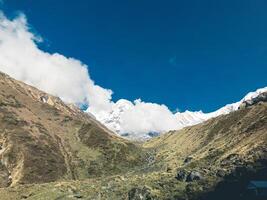 clouds over the mountains, mountains in the fog, during annapurna, annapurna base camp nepal photo