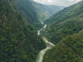 clouds over the mountains, mountains in the fog, during annapurna base camp, ghandruk, nepal photo