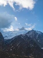 clouds over the mountains, mountains in the fog, during annapurna, annapurna base camp nepal photo