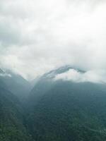 clouds over the mountains, mountains in the fog, during annapurna base camp, ghandruk, nepal photo