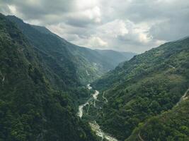 clouds over the mountains, mountains in the fog, during annapurna base camp, ghandruk, nepal photo