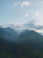 clouds over the mountains, mountains in the fog, during annapurna base camp, ghandruk, nepal photo