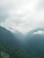clouds over the mountains, mountains in the fog, during annapurna base camp, ghandruk, nepal photo