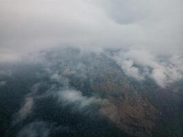 clouds over the mountains, mountains in the fog, during annapurna, annapurna base camp nepal photo