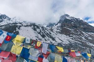tibetan prayer flags in the mountains in nepal, Mountain in nepal, mount everest country, flags of the mountain, Annapurna Base Camp photo