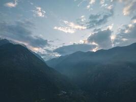 clouds over the mountains, mountains in the fog, during annapurna base camp, ghandruk, nepal photo