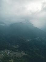 clouds over the mountains, mountains in the fog, during annapurna base camp, ghandruk, nepal photo