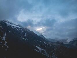 clouds over the mountains, mountains in the fog, during annapurna, annapurna base camp nepal photo