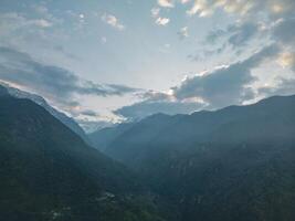 clouds over the mountains, mountains in the fog, during annapurna base camp, ghandruk, nepal photo