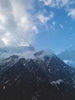 clouds over the mountains, mountains in the fog, during annapurna, annapurna base camp nepal photo